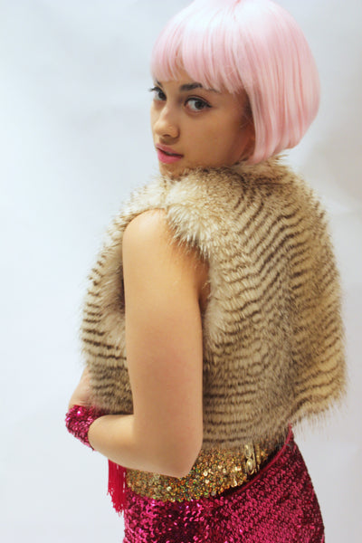 Our model is wearing the High-End Fur Bolero Vest in Blonde Raccoon.