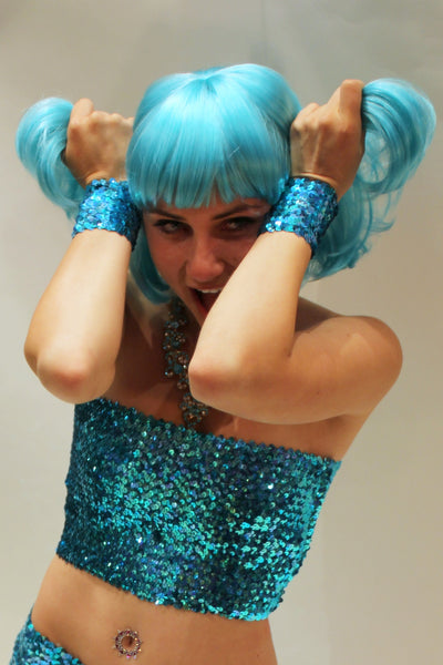 Our model is wearing the Short Sequins Cuffs in Turquoise AB.